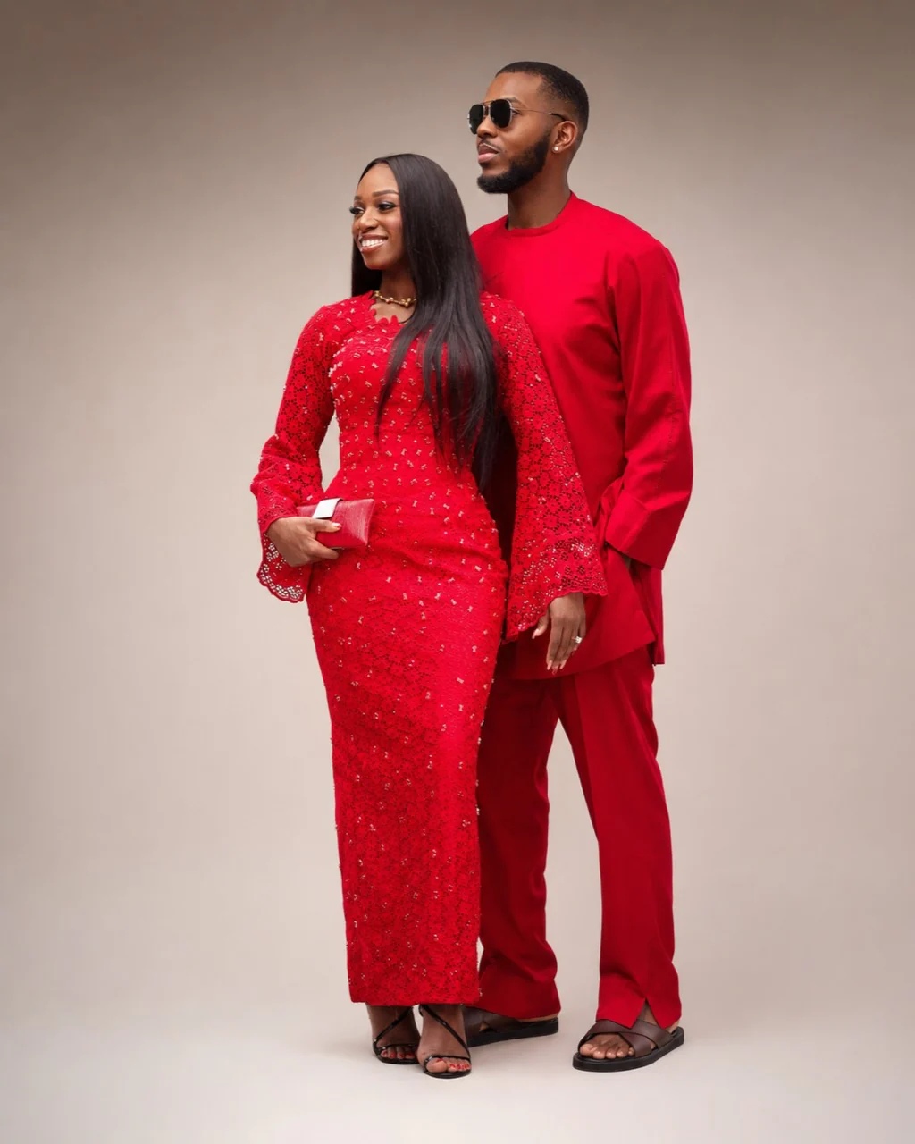 Eniola and Uchenna wearing red traditional attire