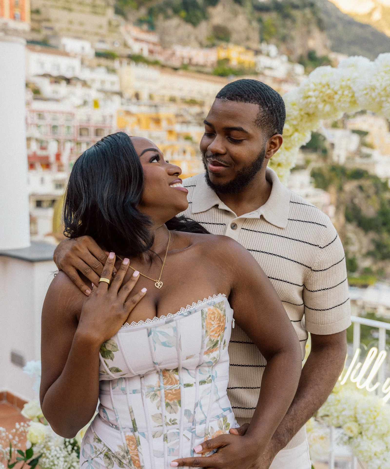 Eniola and Uchenna sharing a joyful engagement portrait in Positano